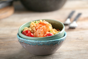 Bowls with delicious shrimp fried rice on table