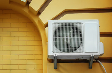 Air conditioner on wall of building outdoors