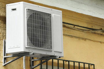 Air conditioner on wall of building outdoors