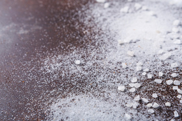 Scattered salt and pepper on dark background