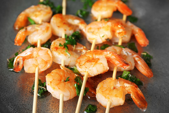 Skewers with delicious grilled shrimps, closeup