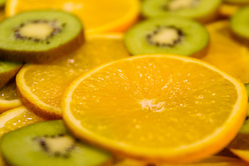Background of the kiwi and orange fruits. Selective focus