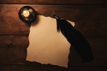 old paper and quill pen in candlelight. top view - obrazy, fototapety, plakaty