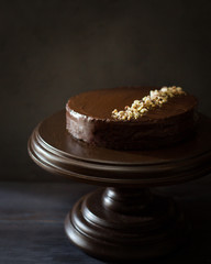 Classic apple chocolate cake with nuts on an  dark wooden background. Copy Space. View blank space for text. Place for text. Food photo. Flat lay, top view