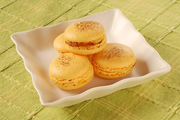 Delicious macarons on white  plate 