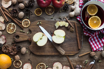 Obraz na płótnie Canvas cut apple and knife on wooden board