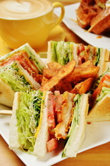 Chicken sandwich with coffee on wooden table