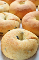 Closeup of a heap of golden bagels.