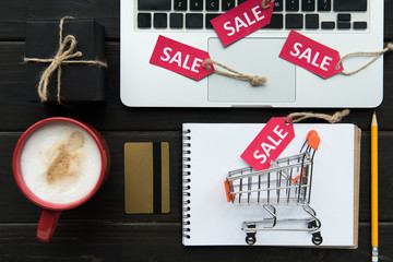 laptop, credit card and sale tags