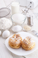 Ingredients for baking delicious cakes on a white wooden table