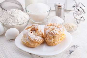 Ingredients for baking delicious cakes on a white wooden table