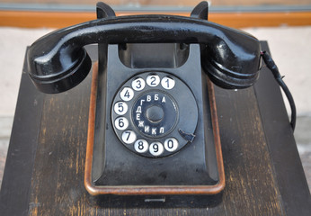 Black vintage old phone with dial numbers letters