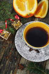 New Year drink: сup of coffee,  orange and Christmas-tree decorations