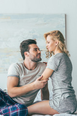 happy young couple on bed