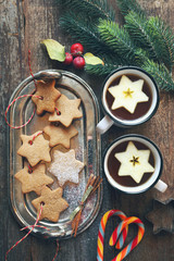 Christmas cinnamon cookies,  sucking candy, two cup of tea and New Year's decoration. Toned image, top view