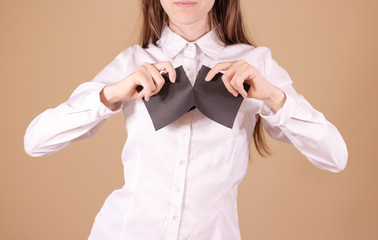 Girl tearing a piece of paper in half blank white flyer brochure booklet. Leaflet presentation....