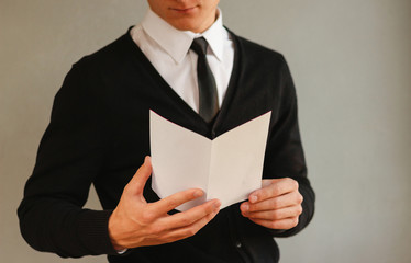 Business man showing blank white flyer brochure booklet. Leaflet presentation. Pamphlet hold hands....