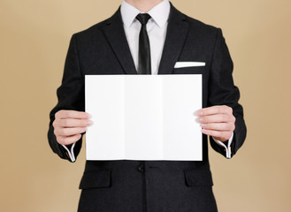 Man showing blank black flyer brochure booklet. Leaflet presentation. Pamphlet hold hands. Man show...