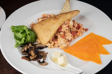 Breakfast with scrambled eggs and tomatoes