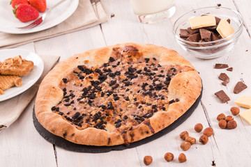Sweet chocolate pizza with cookies. 