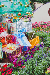Gift box in flower garden, Image for Christmas holiday.
