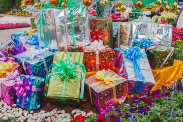 Gift box in flower garden, Image for Christmas holiday