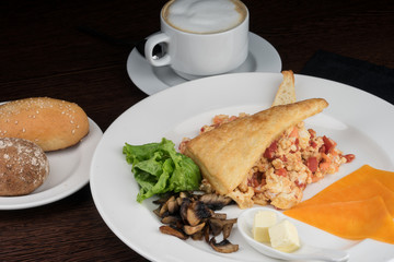 Breakfast with scrambled eggs and tomatoes