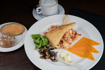 Breakfast with scrambled eggs and tomatoes