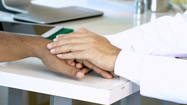 Close up at Asian young doctor encourage to male patient