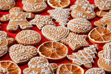 Christmas homemade gingerbread cookies on red background.