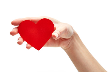 Red heart in woman hand isolated on white