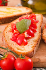 Fototapeta na wymiar Bruschetta bread with basil and chopped tomatoes. 