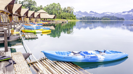 Resort wooden home raft floating and mountain fog on river kwai at Khao Sok National Park, Surat Thani Province, Thailand. Concept image for transportation,boat,nature,scenery,travel,outdoor