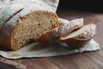 Close-up of chopped fresh rye bread on a linen towel.
