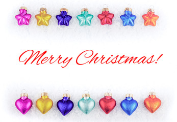 Colorful Christmas tree decorations on snow with Christmas greetings, white background