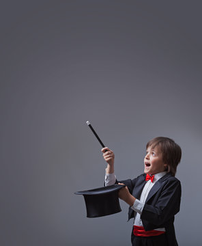 Magician Boy Performing With Magic Wand And Hard Hat