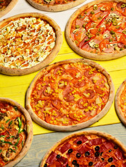 Pizza circles with meat, mushrooms, tomatoes and cheese