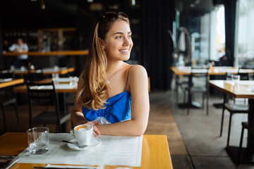 Stunning woman enjoying her coffee