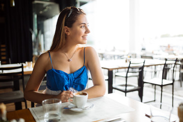 Woman drinking coffee in restaurant