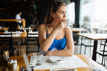 Woman drinking coffee in restaurant