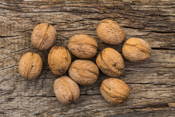 Walnuts on rustic old wooden table. Top view