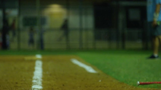Slow motion of baseball player running to first base while another one scores