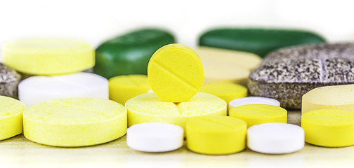 Medicine pills or capsules on wood background.Drug prescription for treatment medication.Pharmaceutical medicament,cure for health.Pharmacy theme, capsule pills with medicine antibiotic in packages.