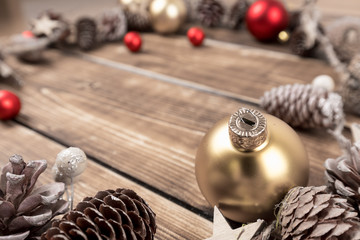 Fototapeta na wymiar christmas balls with pinecones on a wooden background