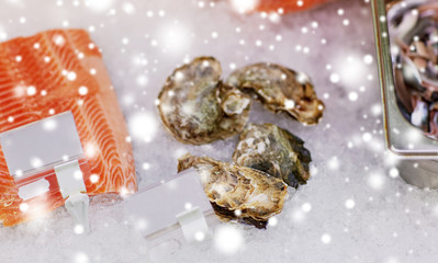 salmon fish and oysters on ice at grocery stall