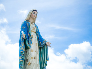 The Blessed Virgin Mary Statue blue sky background.