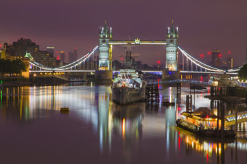 London - The Tower bridge with the ships and riverside at dusk.