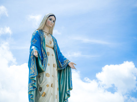The Blessed Virgin Mary Statue blue sky background.