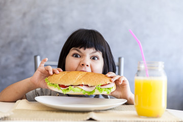 Portrait of little girl having breakfast at home