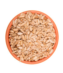 Full bowl of peeled sunflower seeds isolated on white
